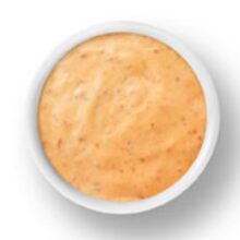A small bowl of creamy orange dipping sauce.