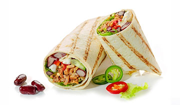 A grilled chicken wrap filled with fresh vegetables and spices.